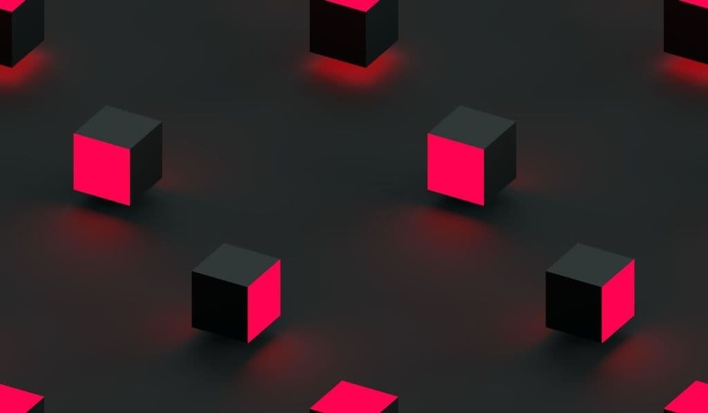 Rows of dark isometric cubes on a charcoal surface, each with one face glowing hot pink.